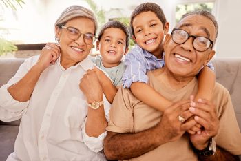 Love, happy family and kids relax with grandparents on a sofa, h