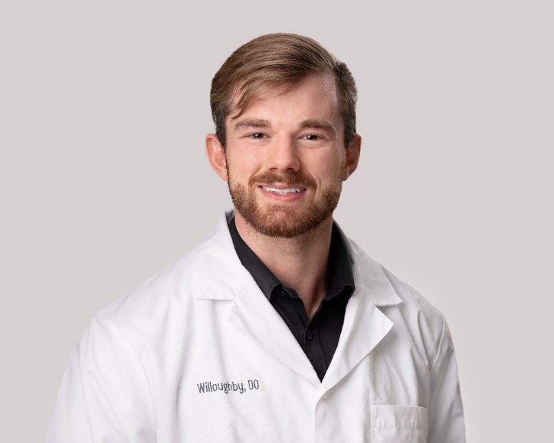 Portrait of David Willoughby, D.O. in a white lab coat