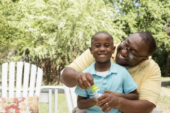 Father and son blowing bubbles