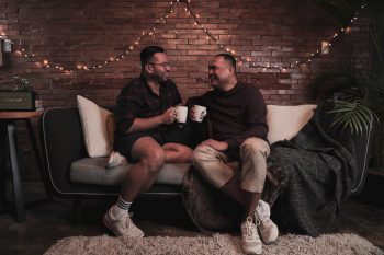 Happy LGBT couple sitting on the couch
