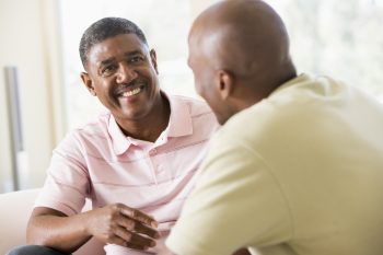 Two men in living room talking