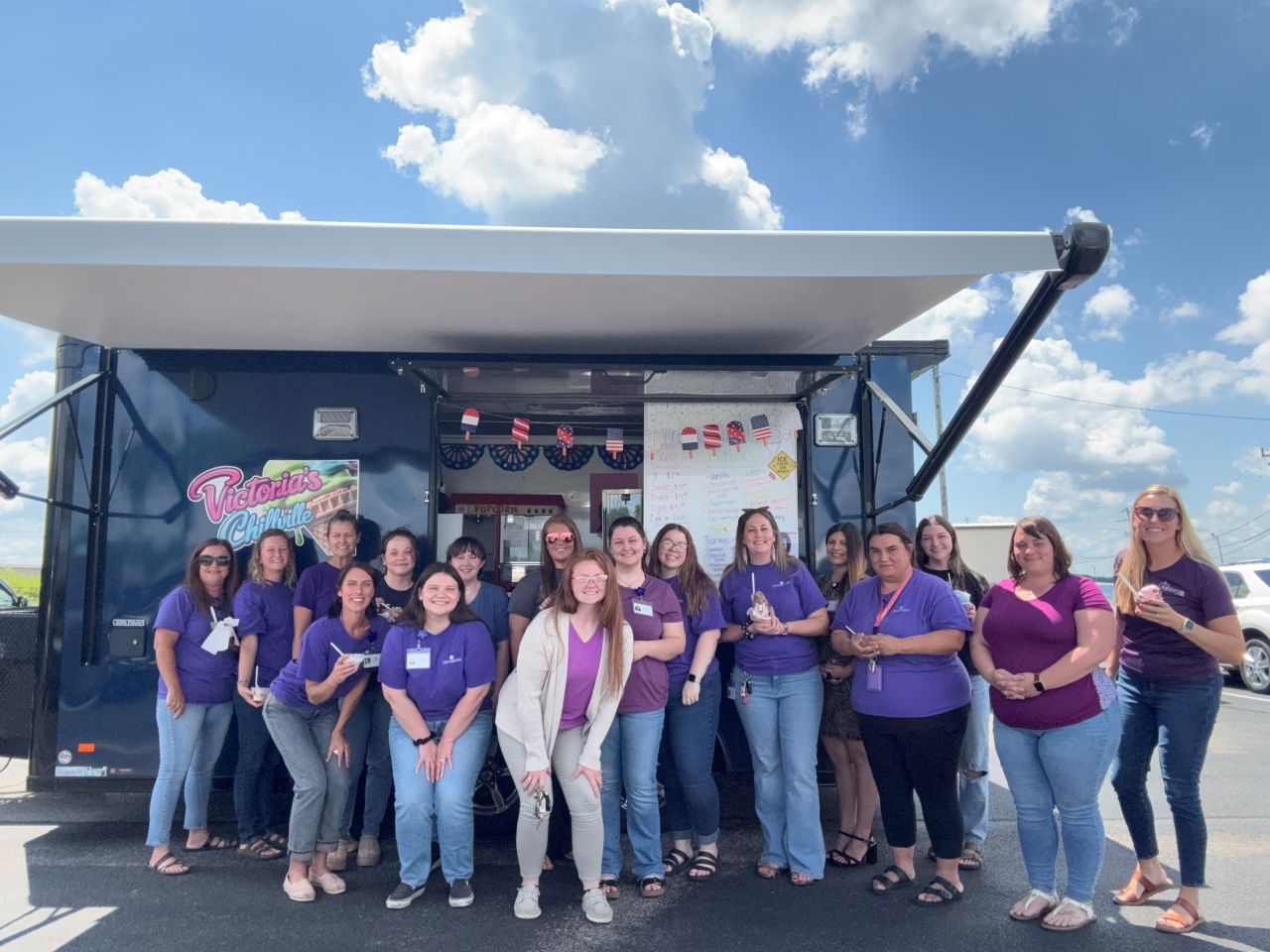 Centerstone staff gathered in front of a food truck enjoying ice cream on a sunny day.