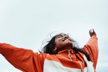 Happy black woman, freedom and sky for success in adventure, travel or achievement in the outdoors. Female winner celebrating goal being free in nature for successful traveling to India in happiness