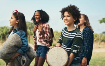 Shot of a group of teenagers walking through nature together at summer camp