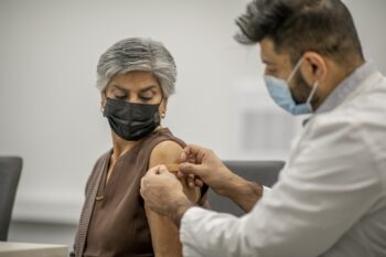 Putting band aid on after vaccination