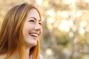Facial portrait of a funny woman face laughing